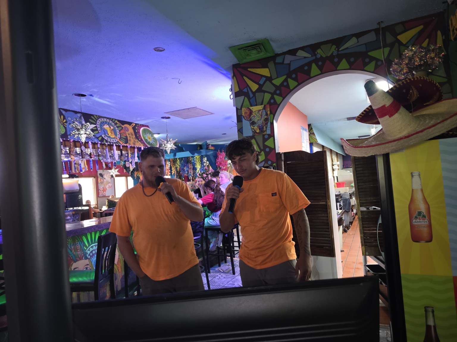 Two singers performing a karaoke duet at Los Cabos