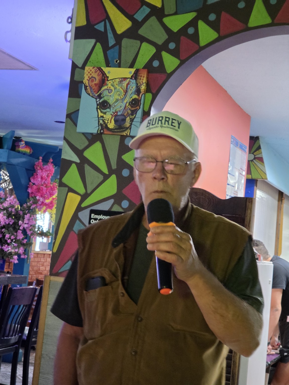 Singer holding a microphone at Los Cabos