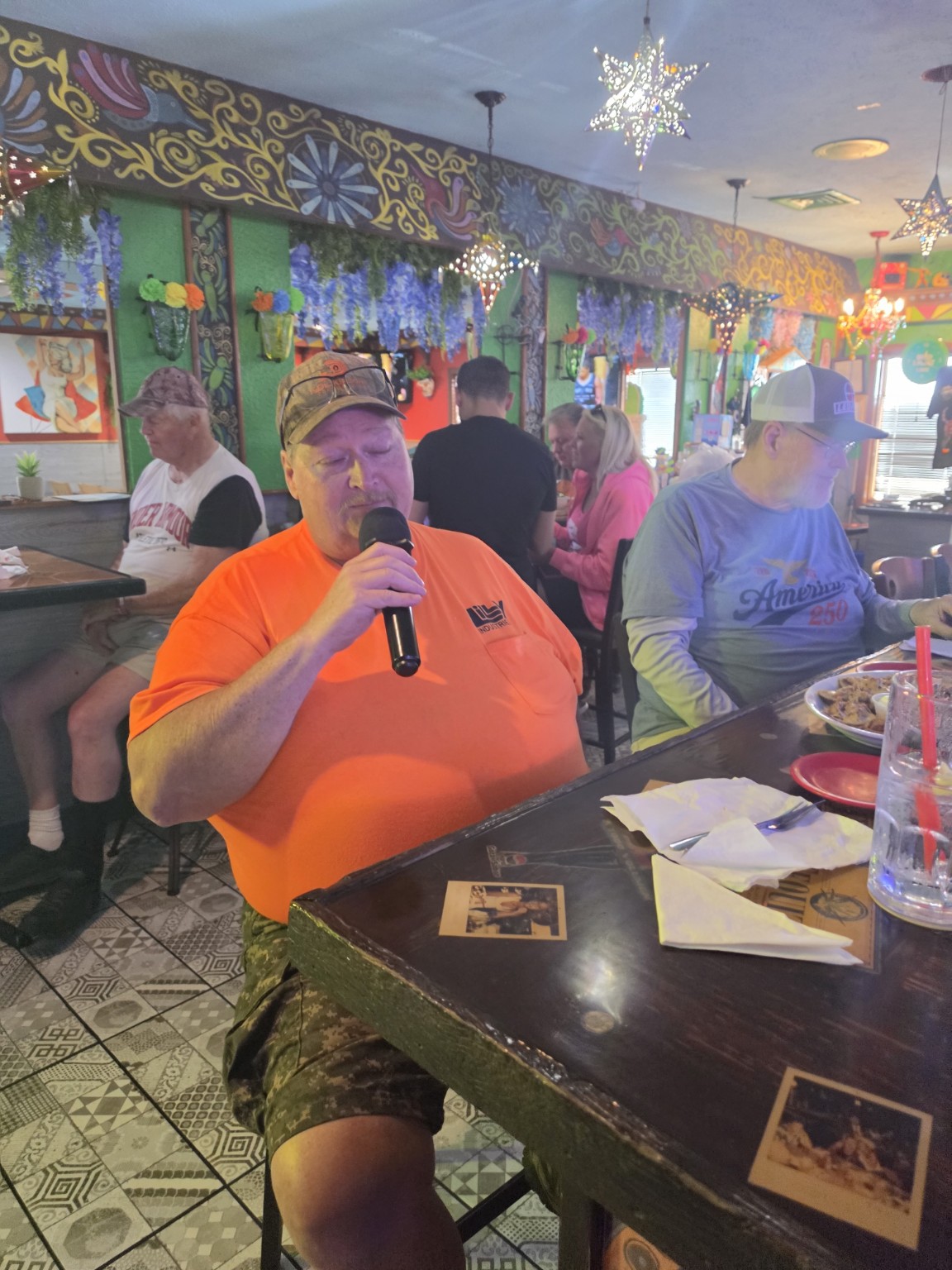 Singer enjoying karaoke from a seat at Los Cabos