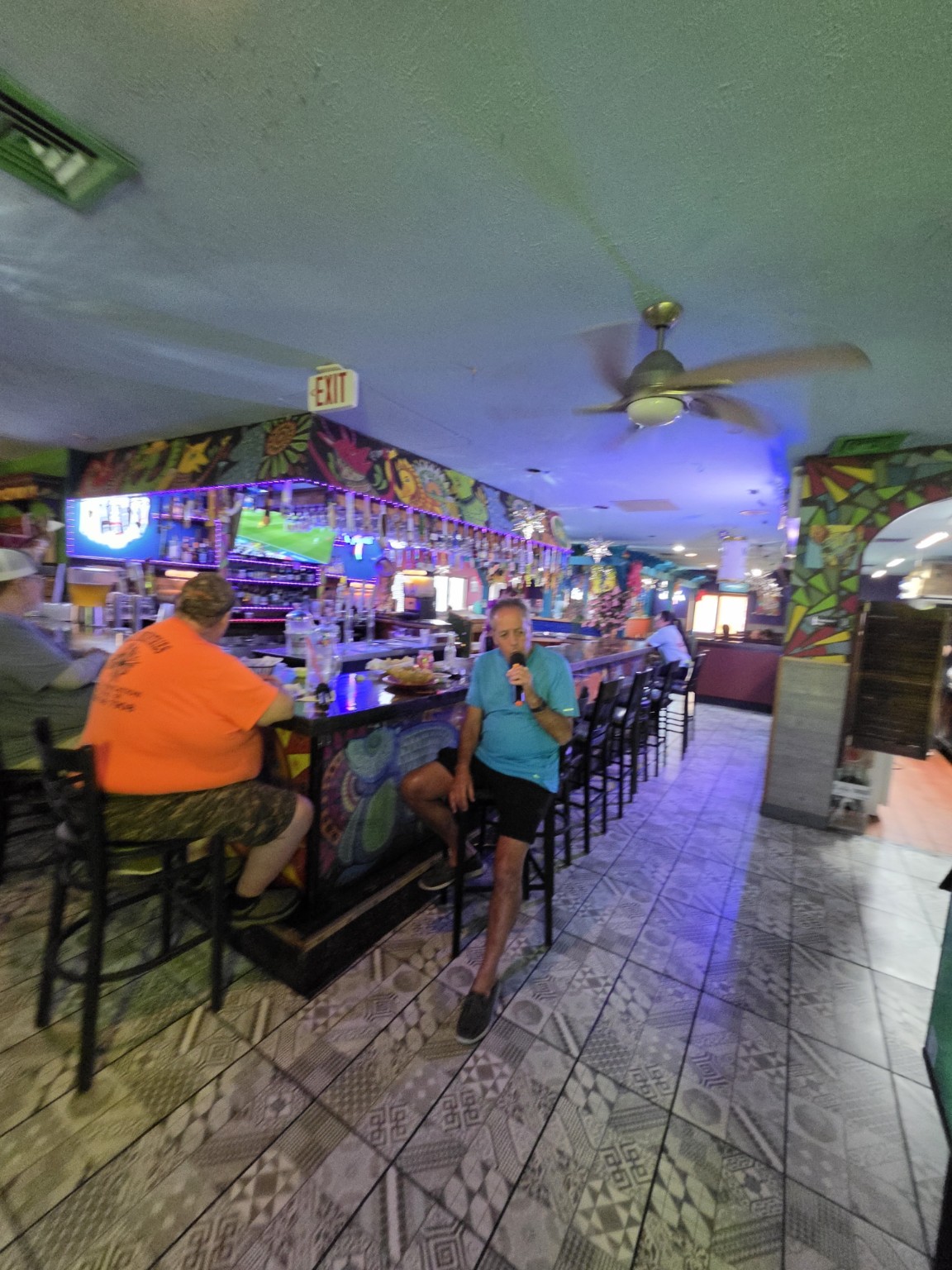 Singer performing beside the bar at Los Cabos