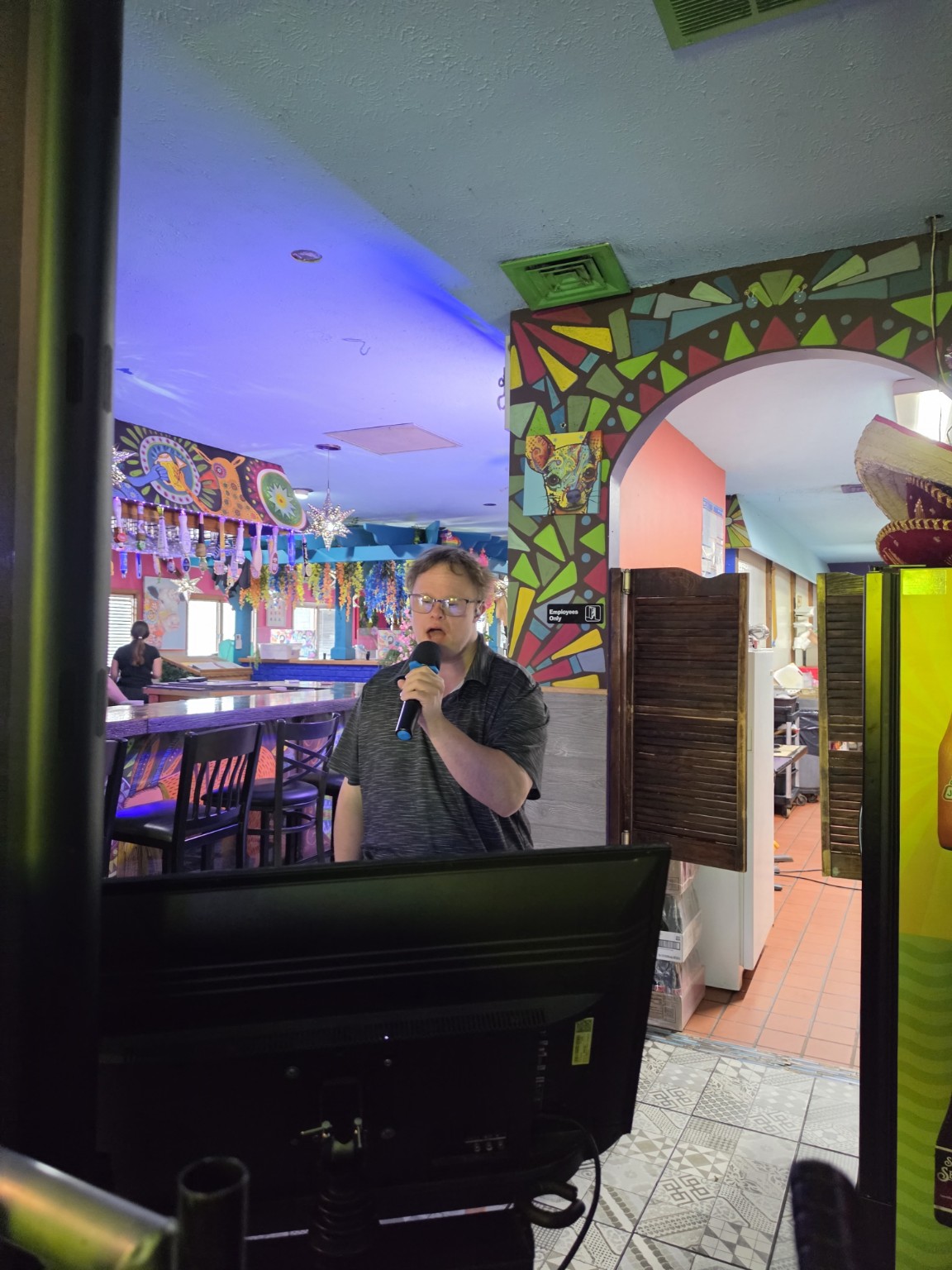 Singer following lyrics on the karaoke display