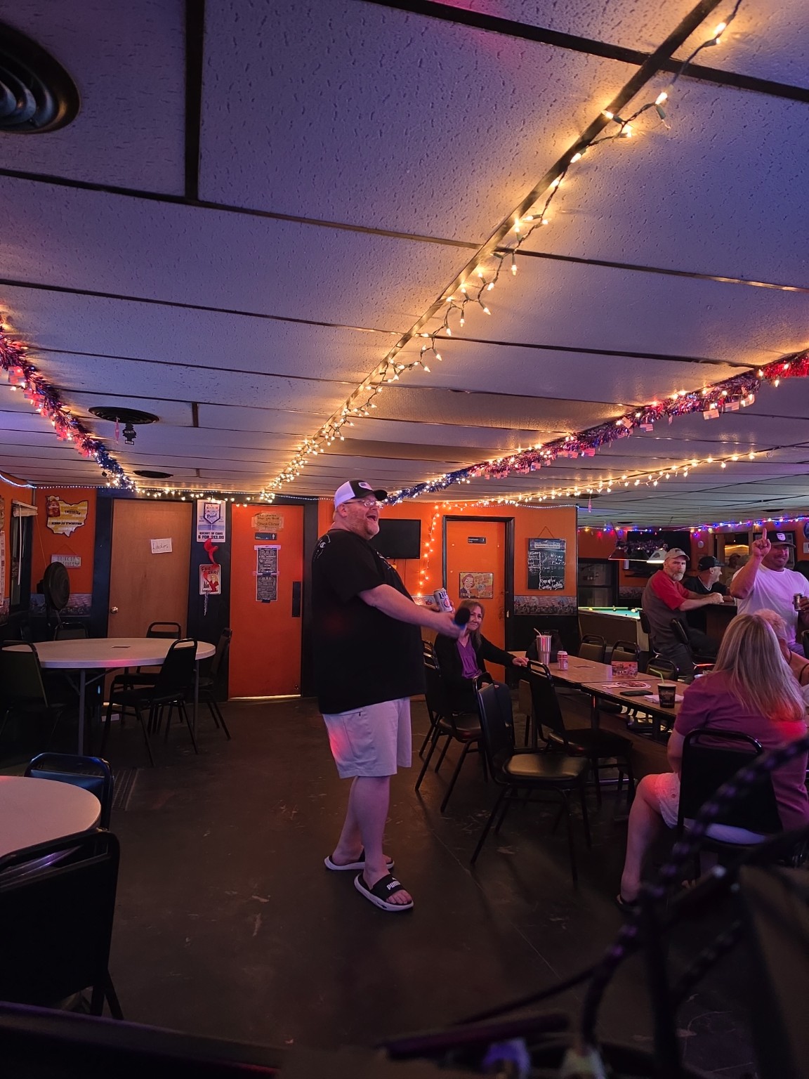 Man singing karaoke in a neighborhood bar