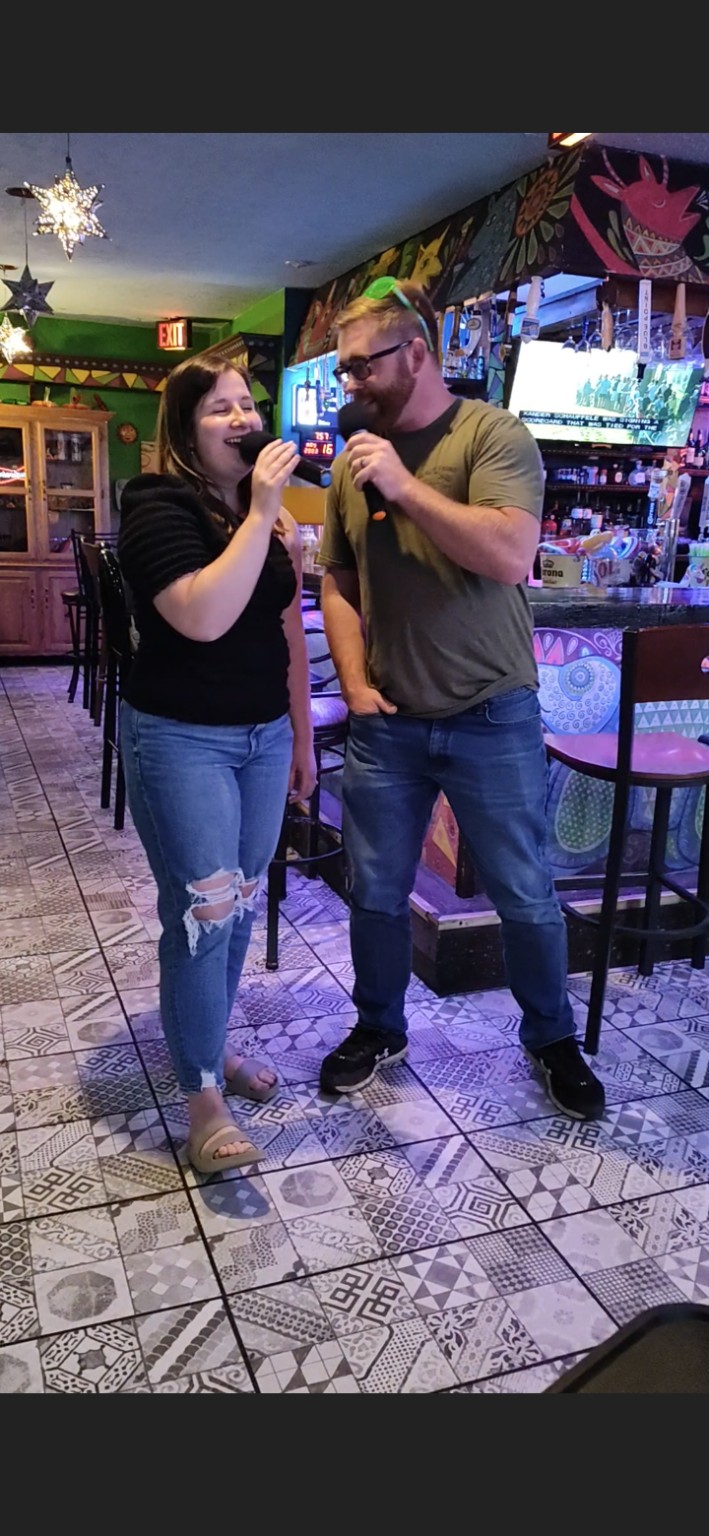 A couple singing a karaoke duet at Los Cabos