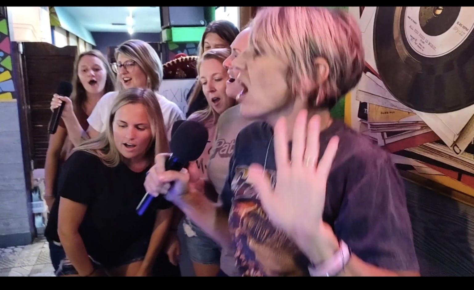 A group of friends singing karaoke together
