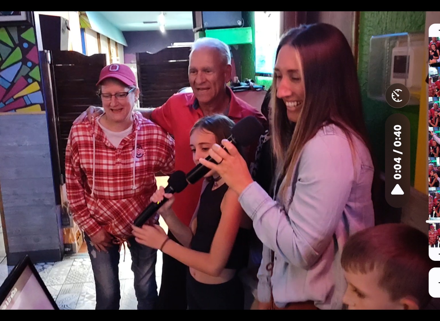 Family and friends sharing karaoke microphones