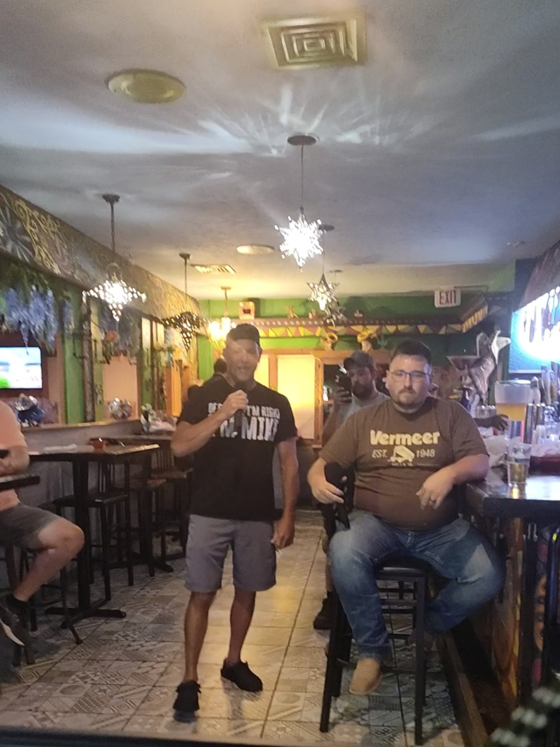 Two men singing karaoke together