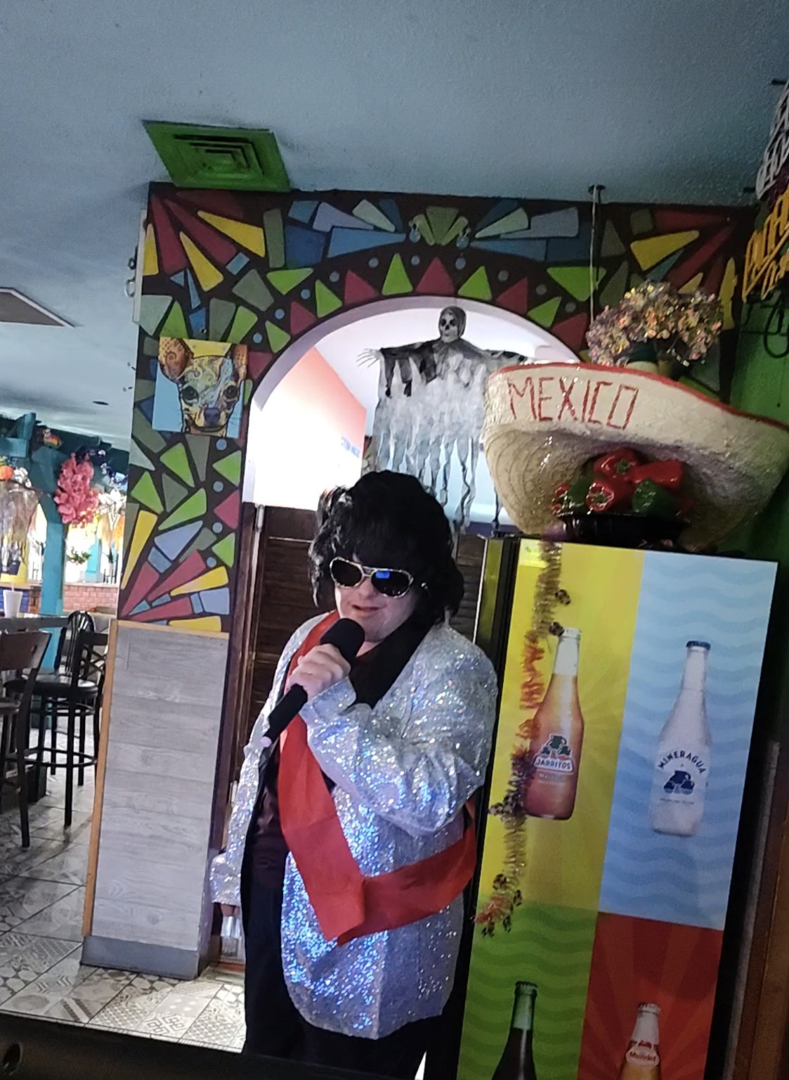 Singer dressed as Elvis performing karaoke
