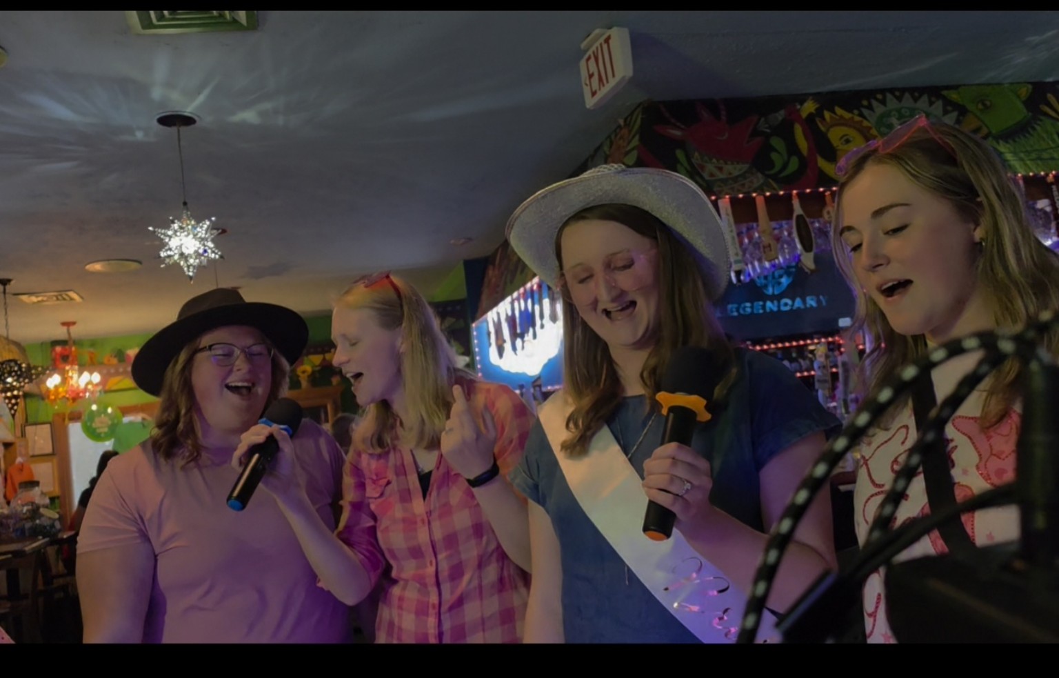 Friends celebrating and singing karaoke together