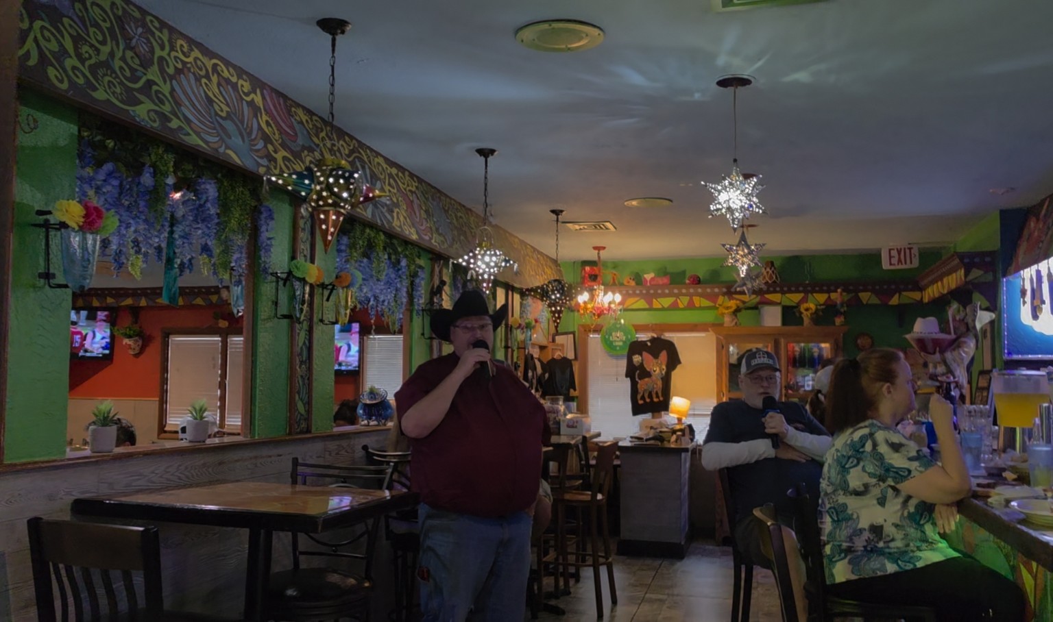 Two singers performing karaoke at Los Cabos