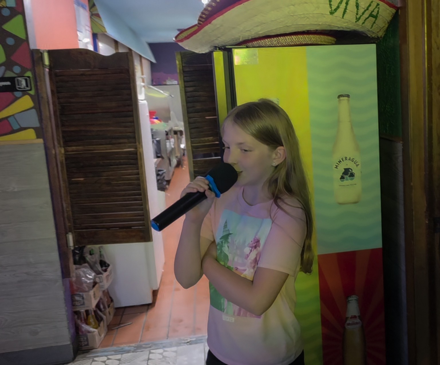 Young singer performing karaoke at Los Cabos